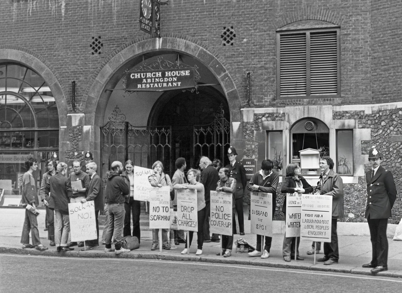 Protestors demonstrate at the start of the public inquiry, headed by Lord Scarman, into the 1981 riot in Brixton, outside Church House in Westminster, London, England, 1981.