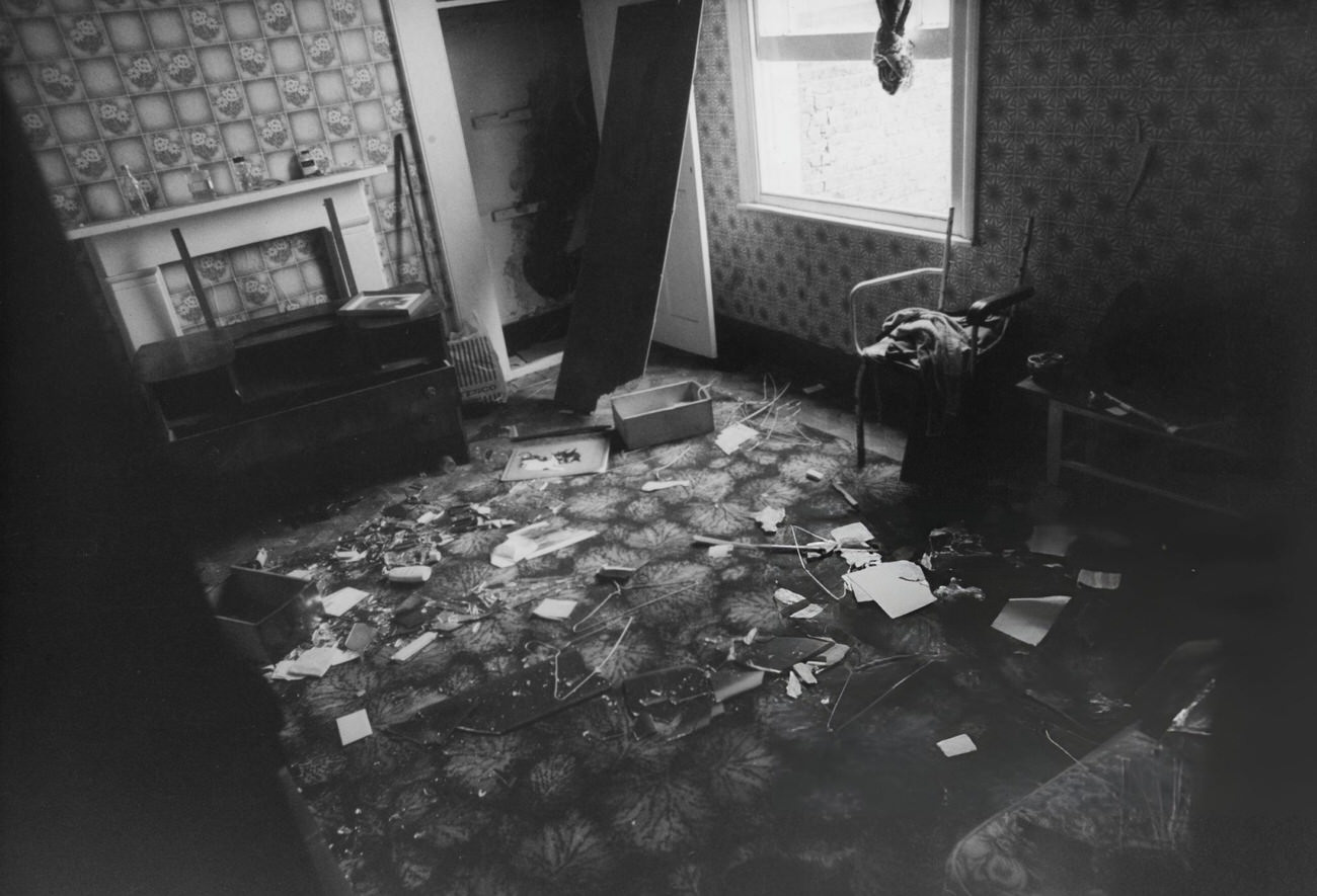 Interior of a property on Railton Road showing damage alleged to have been caused by police when raiding the area in search for drugs and petrol bomb-making equipment in Brixton, London, England, 1981.