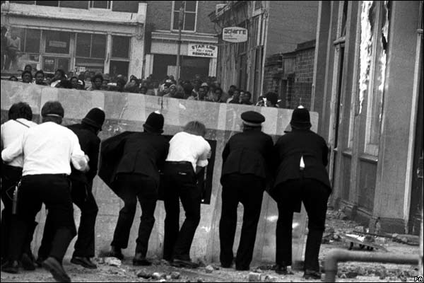 Police confront rioters from behind their shields in Mayall Road, Brixton, 1981.