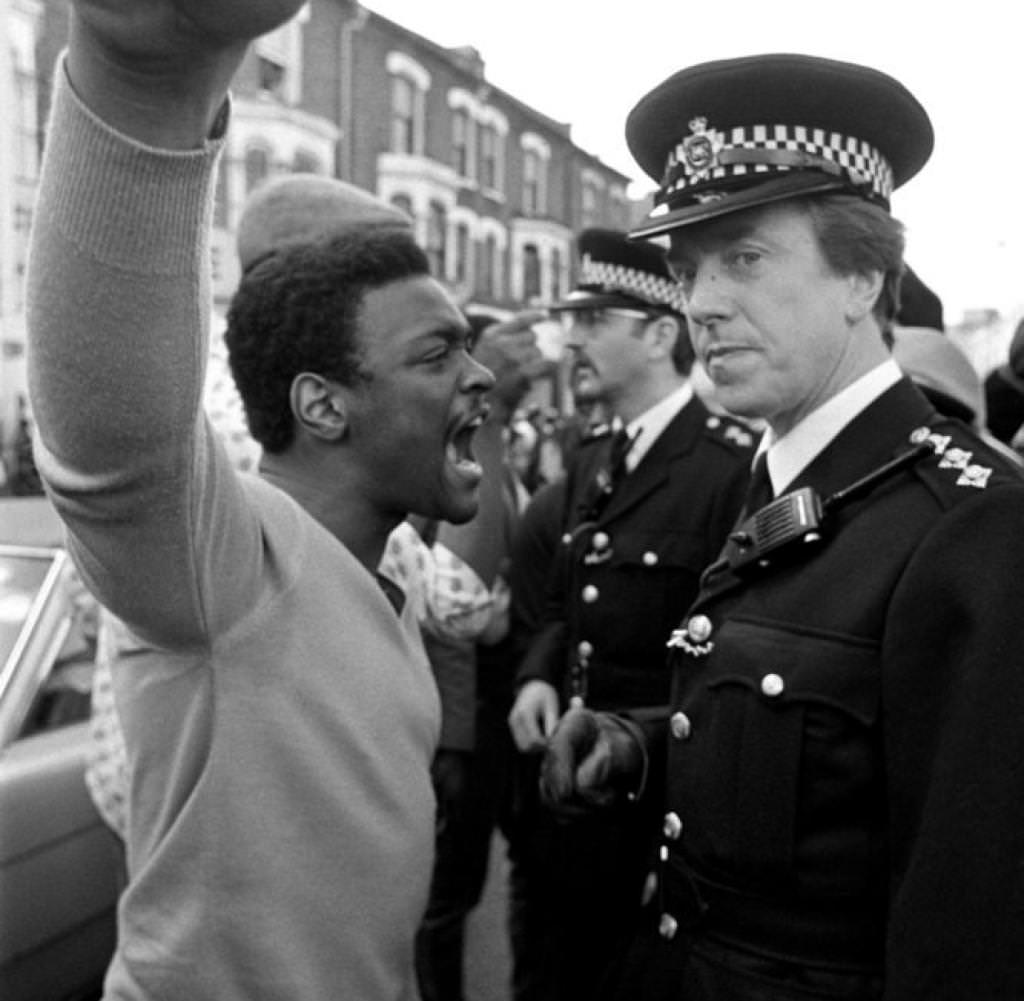 A Brixton man confronts a police officer during the street unrest, 1981.