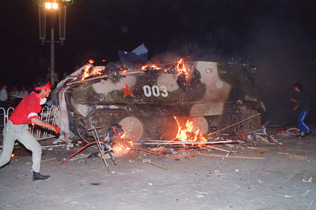 An armored personnel carrier in flames as students attempt to disable the vehicle on June 4, 1989.