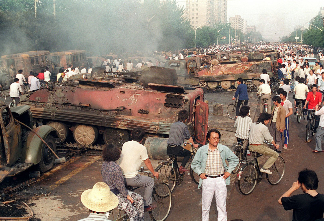 Beijing residents inspect the interior of some of more than 20 armored personnel carriers burned by demonstrators to prevent the troops from moving into Tiananmen Square.