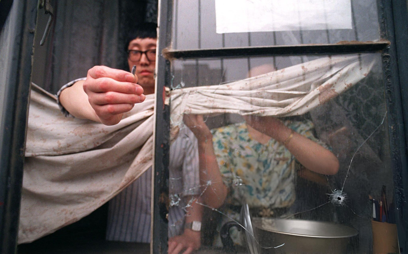 A Beijing resident shows a slug from the automatic rifle fired by the army, 1989.