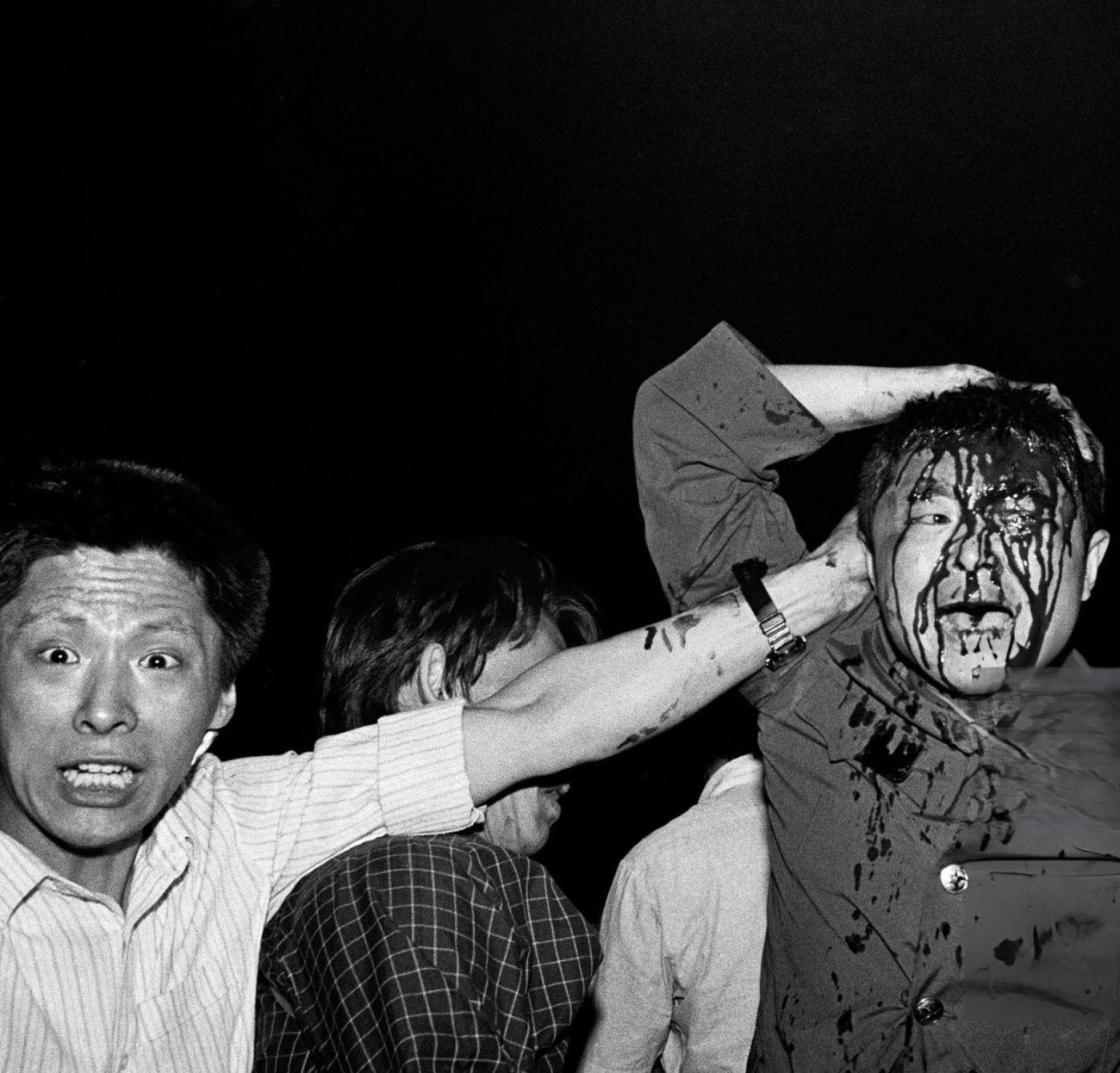 A wounded soldier of the Chinese army is rescued by students, 1989.