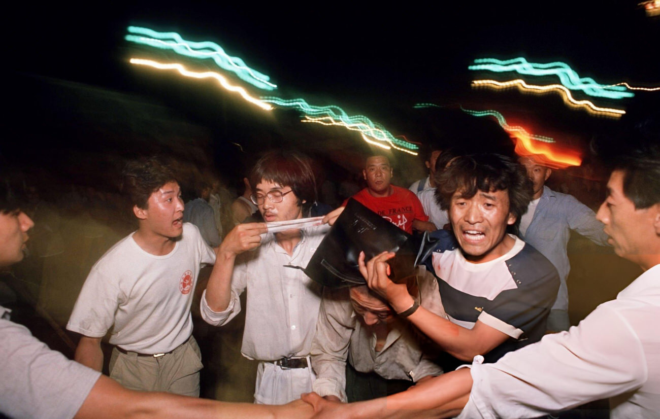 Pro-democracy demonstrators come to the aid of a wounded soldier, 1989.