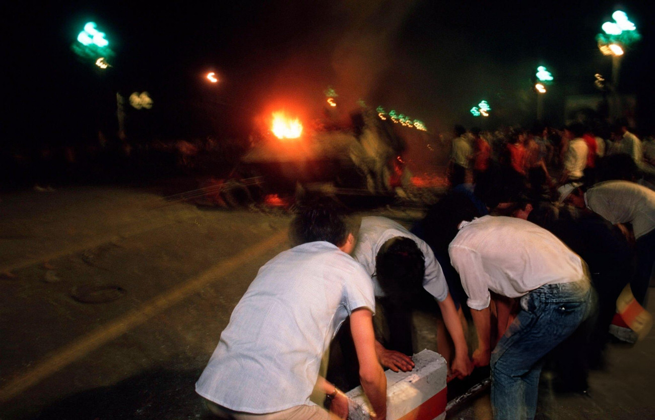 Pro-democracy demonstrators pull barricades across Changan Avenue, 1989.