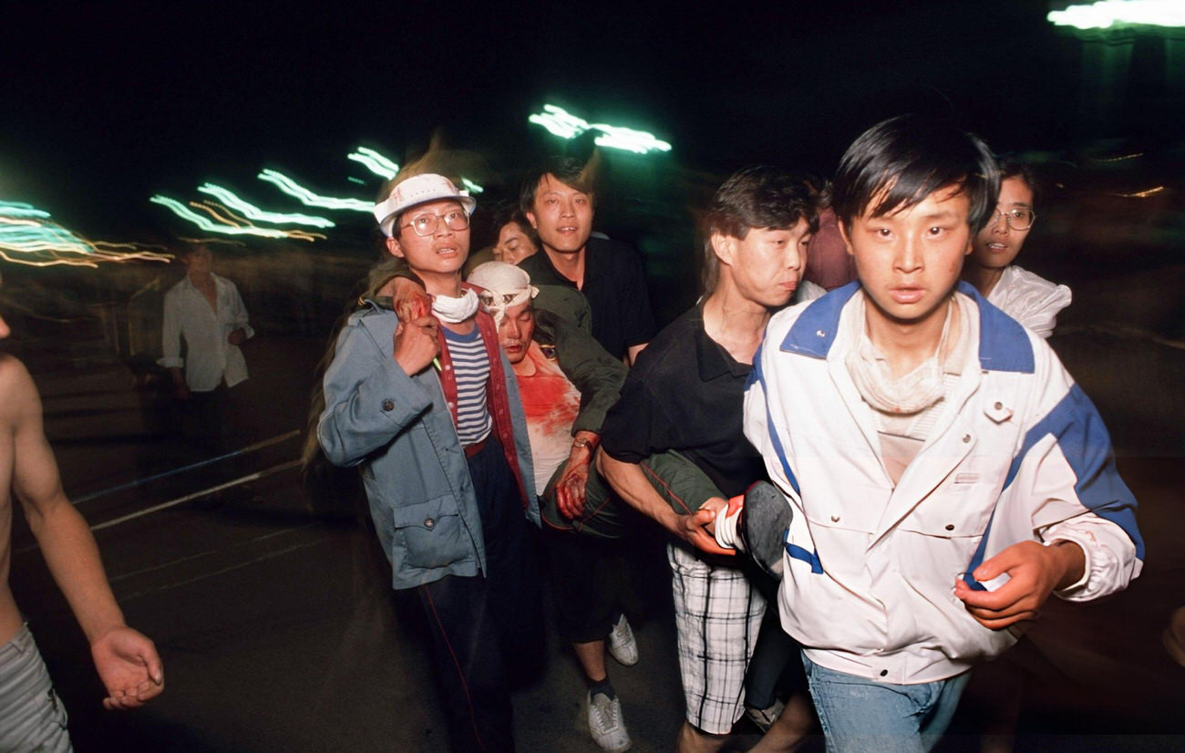 Pro-democracy demonstrators come to the aid of a wounded soldier, 1989.