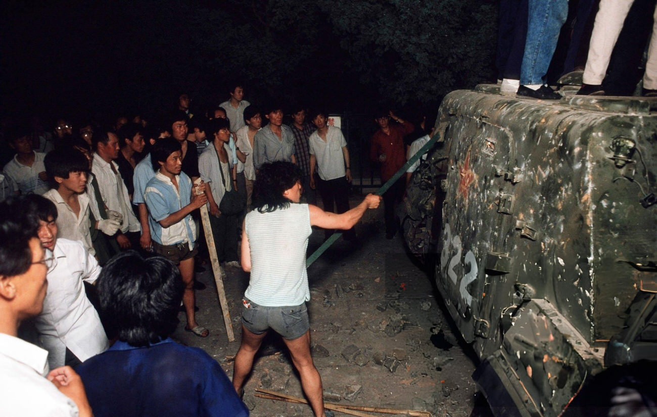 Pro-democracy demonstrators bash attack an armored personnel carrier, 1989.