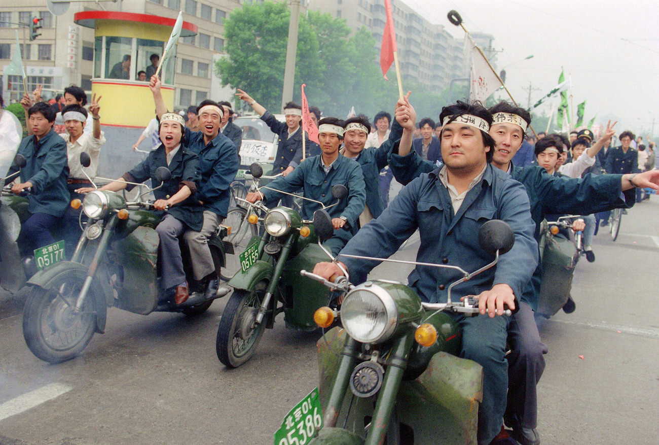 Riding motorbikes, Chinese workers parade through Beijing streets on May 18, 1989, in support of student hunger strikers.