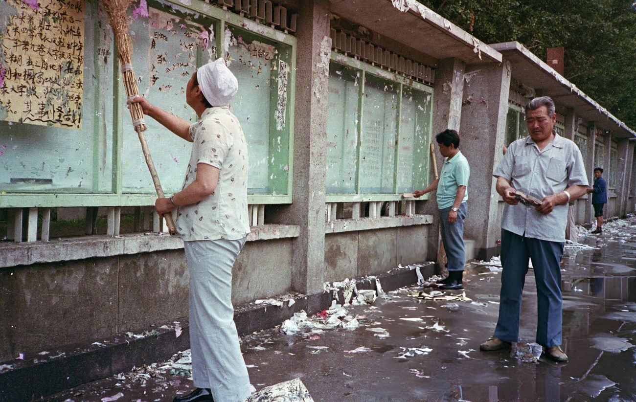 Workers clean their posters from bulletin boards, 1989.