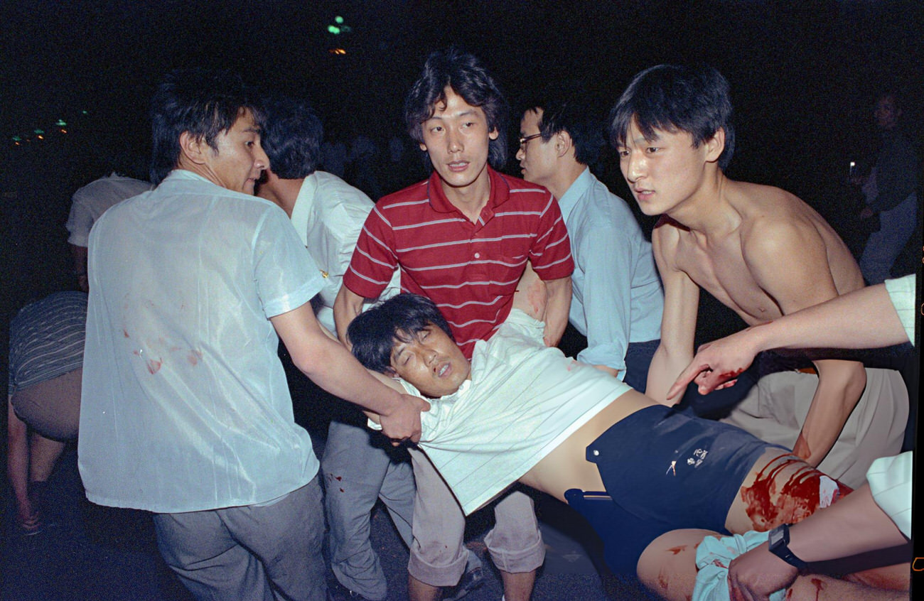 People transport a wounded man, 1989.