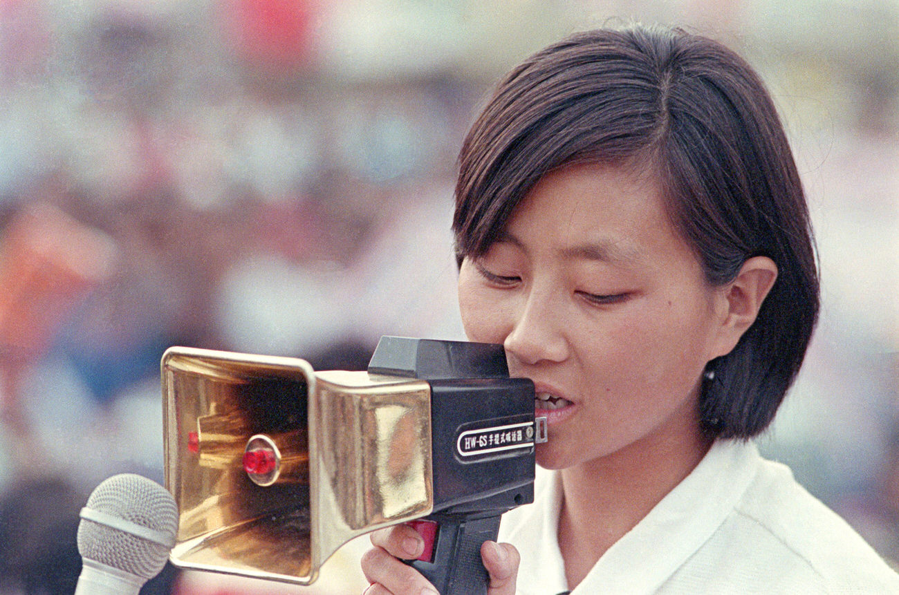 A leader of the pro-democracy protests speaks to the crowds through a golden bullhorn.