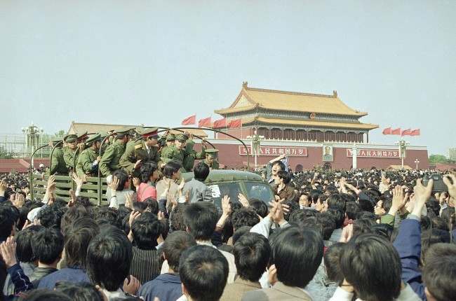 Chinese marchers are jubilant as they surround and stop an army truck at Tiananmen Square, April 27, 1989 in Beijing.