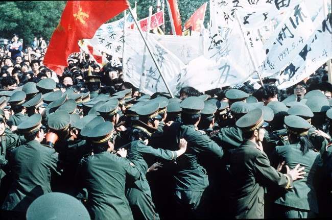 Chinese police try in vain to contain a huge crowd of student marchers during a pro-reform demonstration in Beijing, China, May 4 1989.