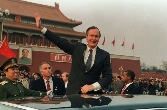 President Bush stands on his car and waves in Tiananmen Square in Beijing during a visit to China in this Feb. 25, 1989 photo.