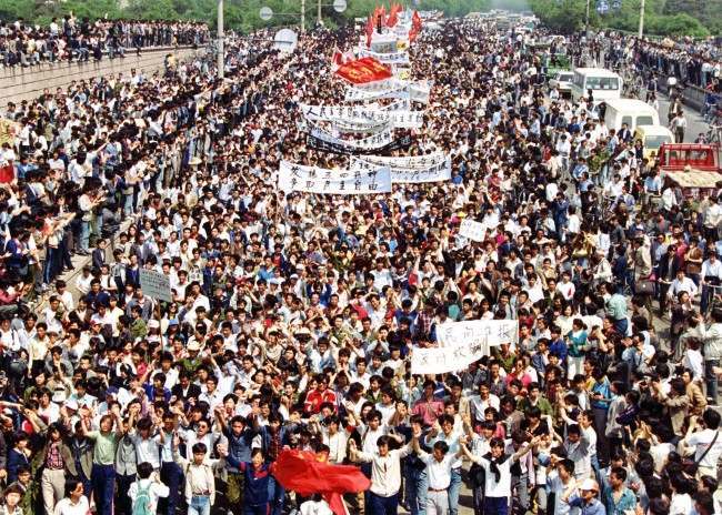 More than seven thousand students from local colleges and universities march to Tiananmen Square, Beijing, May 4, 1989, to demonstrate for government reform.