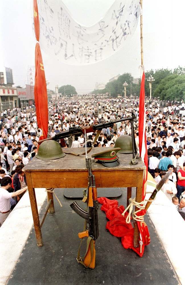 Chinese military items, including rifles, helmets, and a hat, are displayed during the pro-democracy demonstration that lasted from mid-April to early June 1989 on Beijing’s Tiananmen Square. The demonstration ended with a government crackdown on June 4, 1989, leaving hundreds dead.