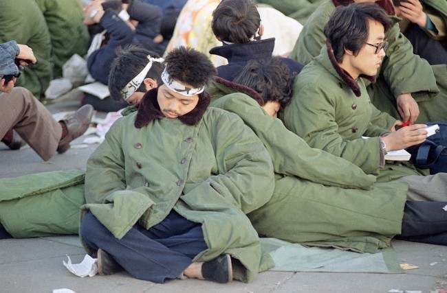 Student protesters in Beijing’s Tiananmen Square sleep leaning on one another at sunrise, Sunday, May 14, 1989 in Beijing. The protesters, some of them on a hunger strike, plan to remain in the square for the official welcoming ceremony for Soviet leader Mikhail Gorbachev on Monday.