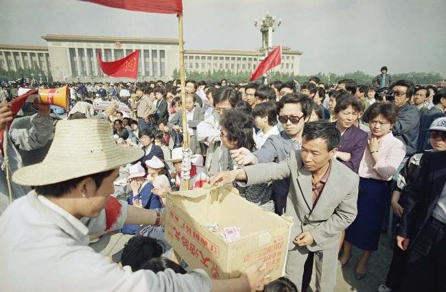 A Beijing University student collects contributions to support the hunger strike from passers by in Beijing’s Tiananmen Square, Tuesday, May 16, 1989. The strike is now is its fourth day.