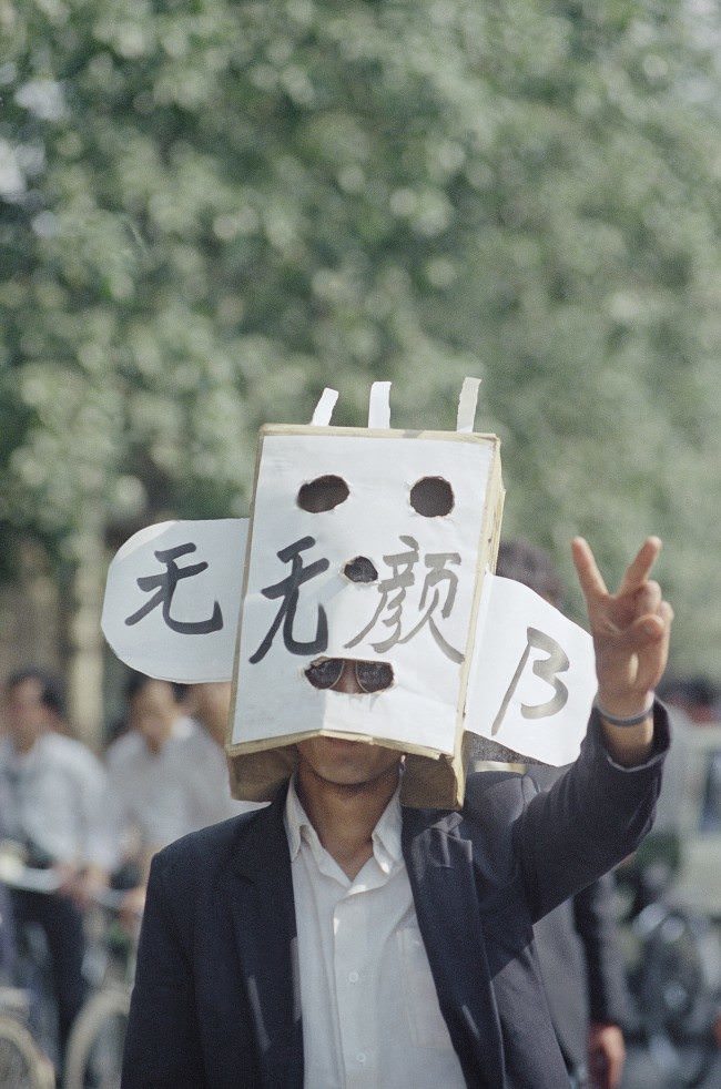 A student protestor flashes a victory sign during a demonstration in Tiananmen Square, Wednesday, May 17, 1989, Beijing, China.