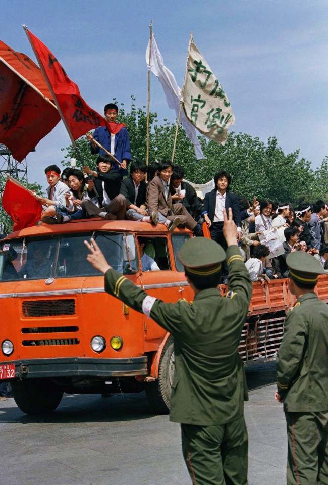 A Beijing policeman encourages university students demonstrating for democratic reforms on Friday, May 19, 1989 in Beijing’s Tiananmen Square.