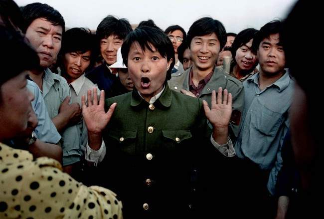 A woman soldier sings among pro-democracy protesters occupying Beijing’s Tiananmen Square, about June 2, 1989. Police and military would occasionally mix with protesters in an attempt to keep the demonstration peaceful. In the early morning hours of June 4, 1989, soldiers overran the square, leaving hundreds dead overnight.