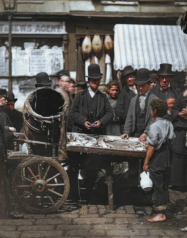 Men purchase fish in St. Giles, 1890s.