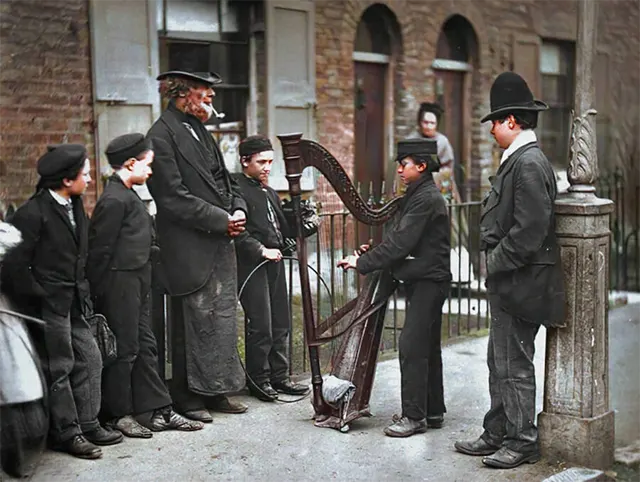 Italian street musicians perform in public, 1890s.