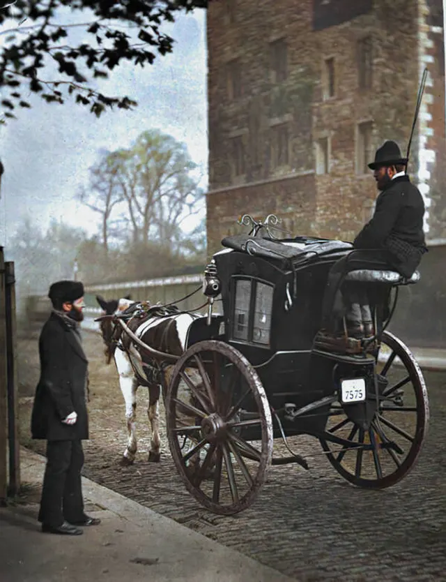 A London cab driver sits on his hansom cab, 1890s.