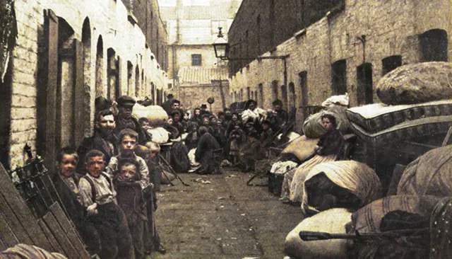 A London slum family is pictured with all their belongings, 1901.