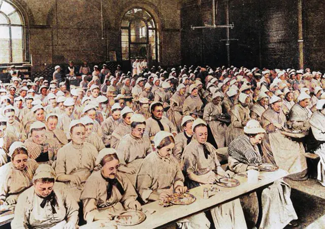 Women eating dinner at a workhouse in St. Pancras, 1900.