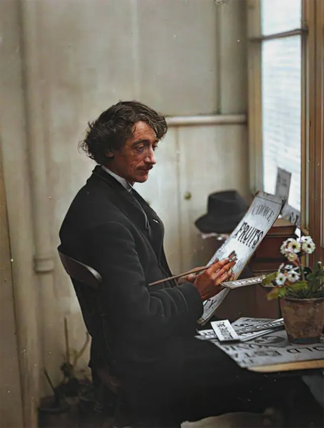 A sign writer sits in his studio, 1890s.