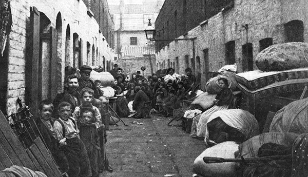 This 1901 photo shows a family recently evicted from slum housing with all of their possessions.