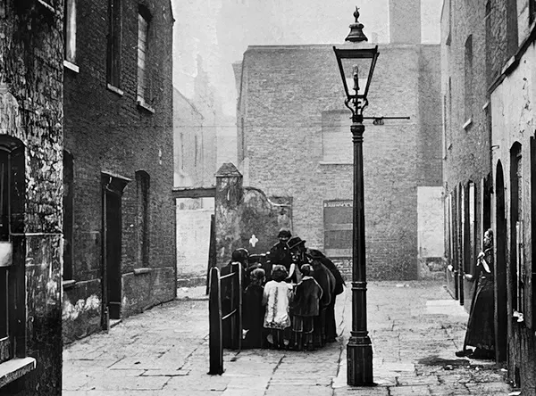 A slum street in an area marked for demolition. 1901.