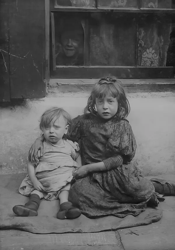 Two children in Spitalfields, one of the worst slums in London. 1903.