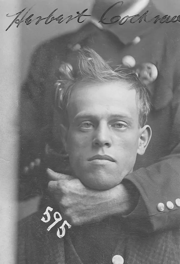 An unidentified member of the Omaha police force holds Herbert Cockran in a headlock during his mugshot in November 1899. Cockran was arrested on burglary charges.