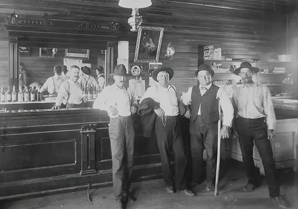 Men pose in a Wild West saloon.