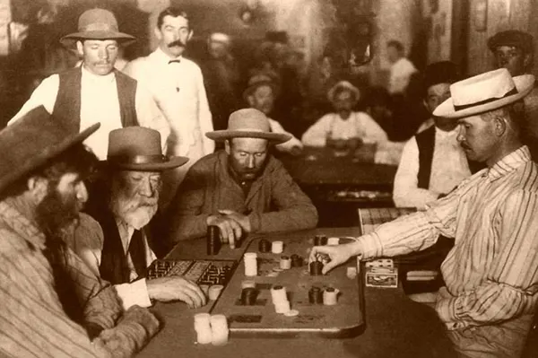 Gamblers play Faro in an Arizona saloon, 1895.