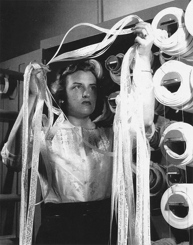 “Human computer” Doris Baron, pictured in 1955, works with tape from machines measuring air pressure.