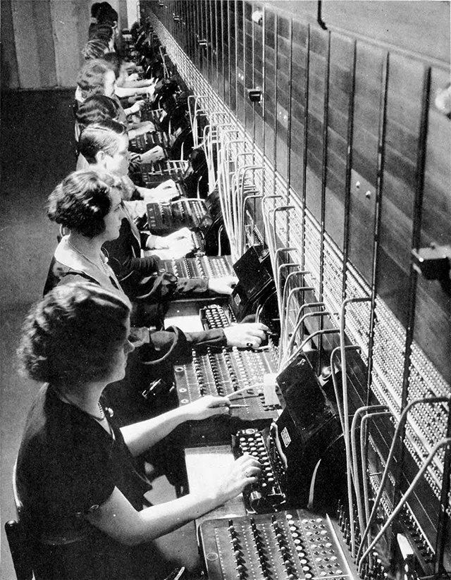 A group of operators working on an AT&T telephone switchboard.