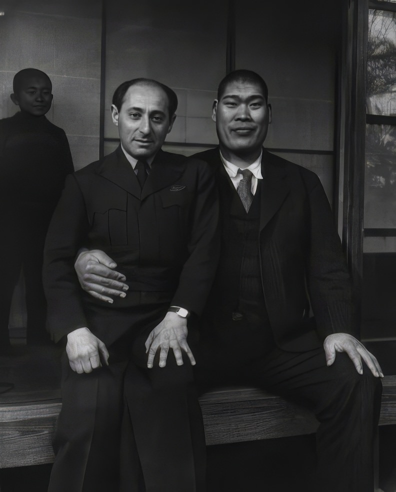 Alfred Eisenstaedt sits on the lap of Tomojiro Sakata, a former sumo wrestling champion and candidate for the People's Labor Party, Tokyo, 1946.