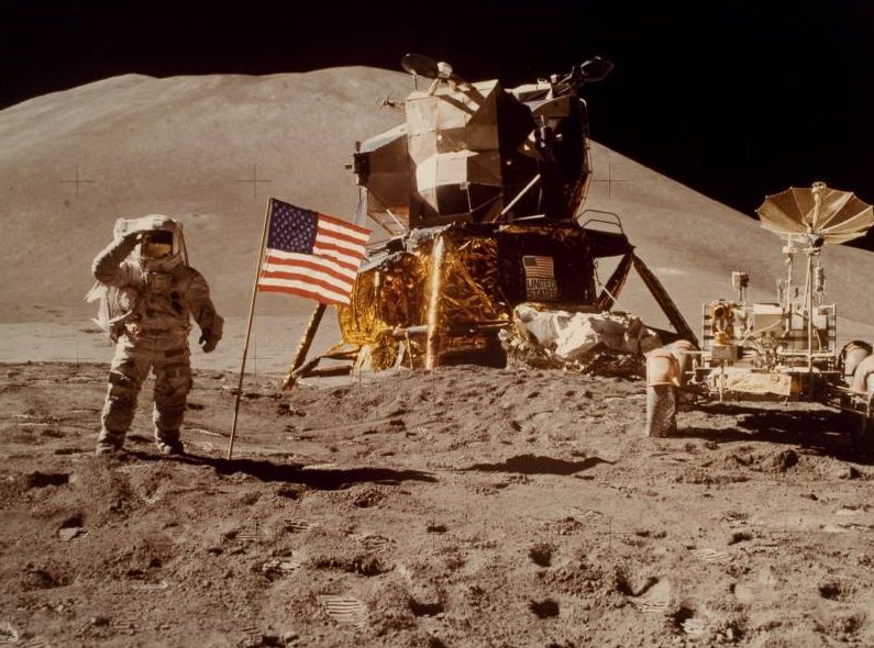 Astronaut James Irwin gives salute beside U.S. flag during lunar surface extravehicular activity (EVA)