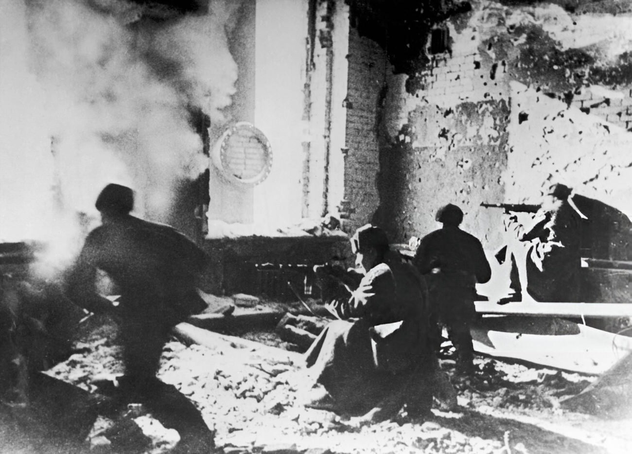 Russian soldiers target the Germans from within an abandoned building during the Battle of Stalingrad, 1942.