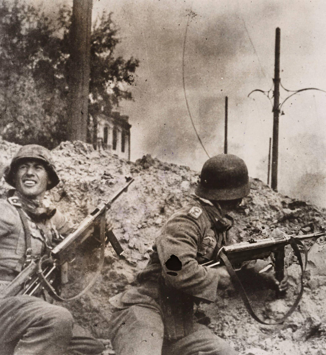 Two German soldiers shelter in a crater during a street fight in Stalingrad, 1942.