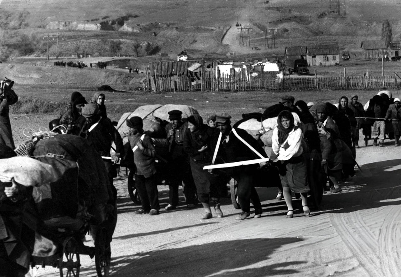 Refugees leaving Stalingrad with hand drawn cars filled with their possessions, 1942.