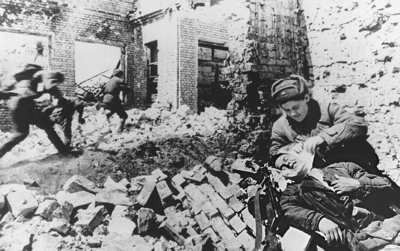 Soviet Soldiers Leaping As A Military Male Nurse Treats A Wounded Soldier, 1942.