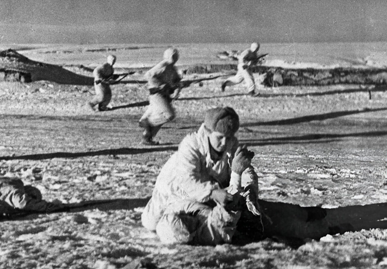 A medic rendering first aid to a wounded red army man, 1942.