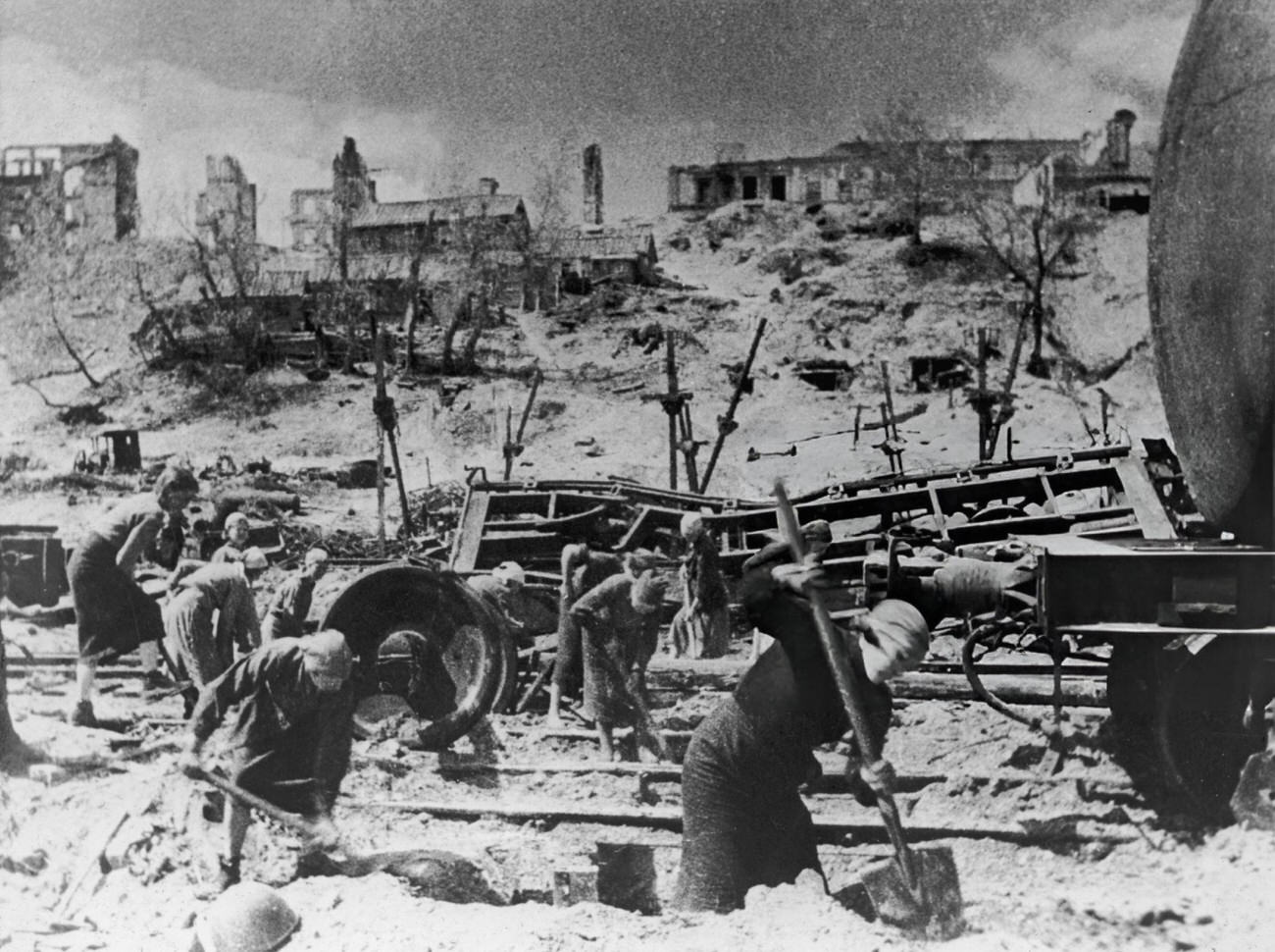 Women digging near damaged train tracks during the Battle of Stalingrad, 1942.