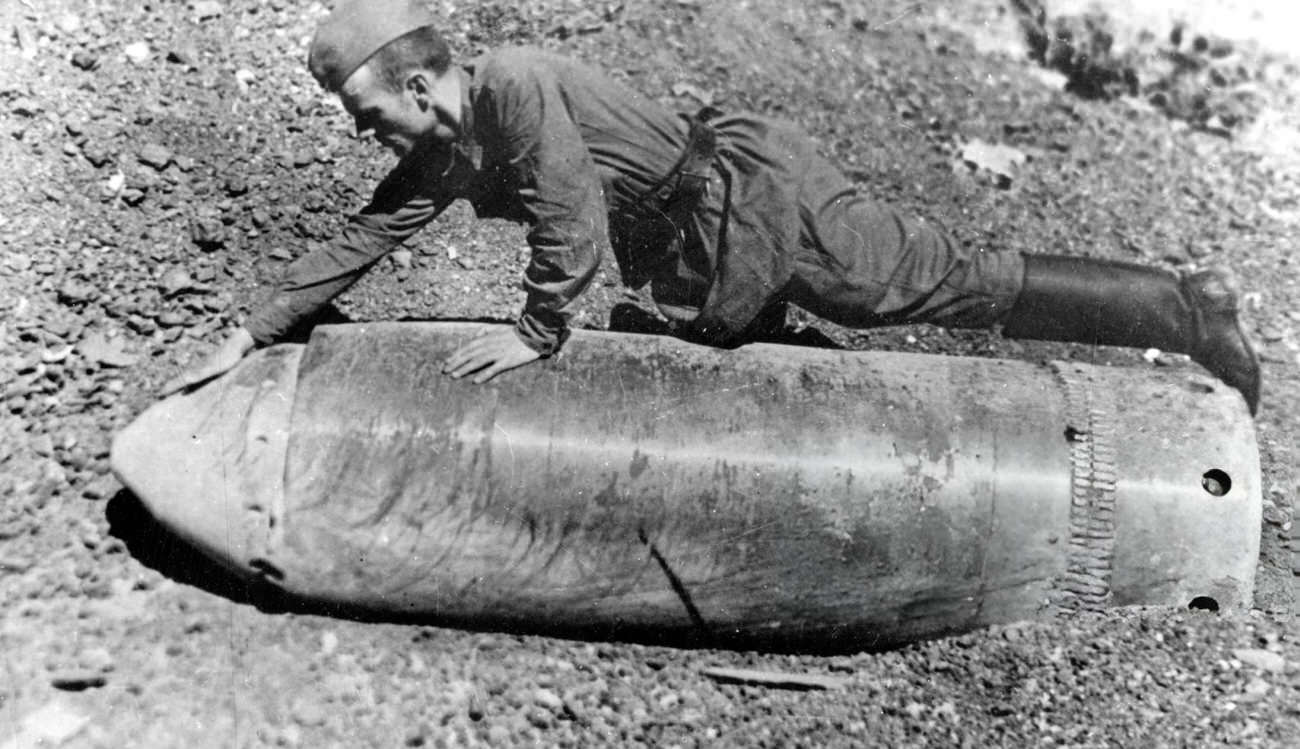 A Soviet soldier examines a huge-calibre projectile fired at Stalingrad by the Germans, 1942.