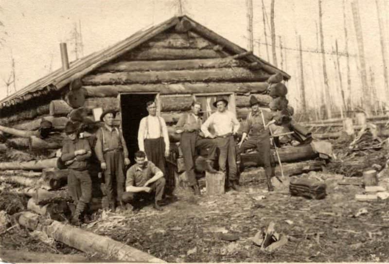 Seven men and a log cabin